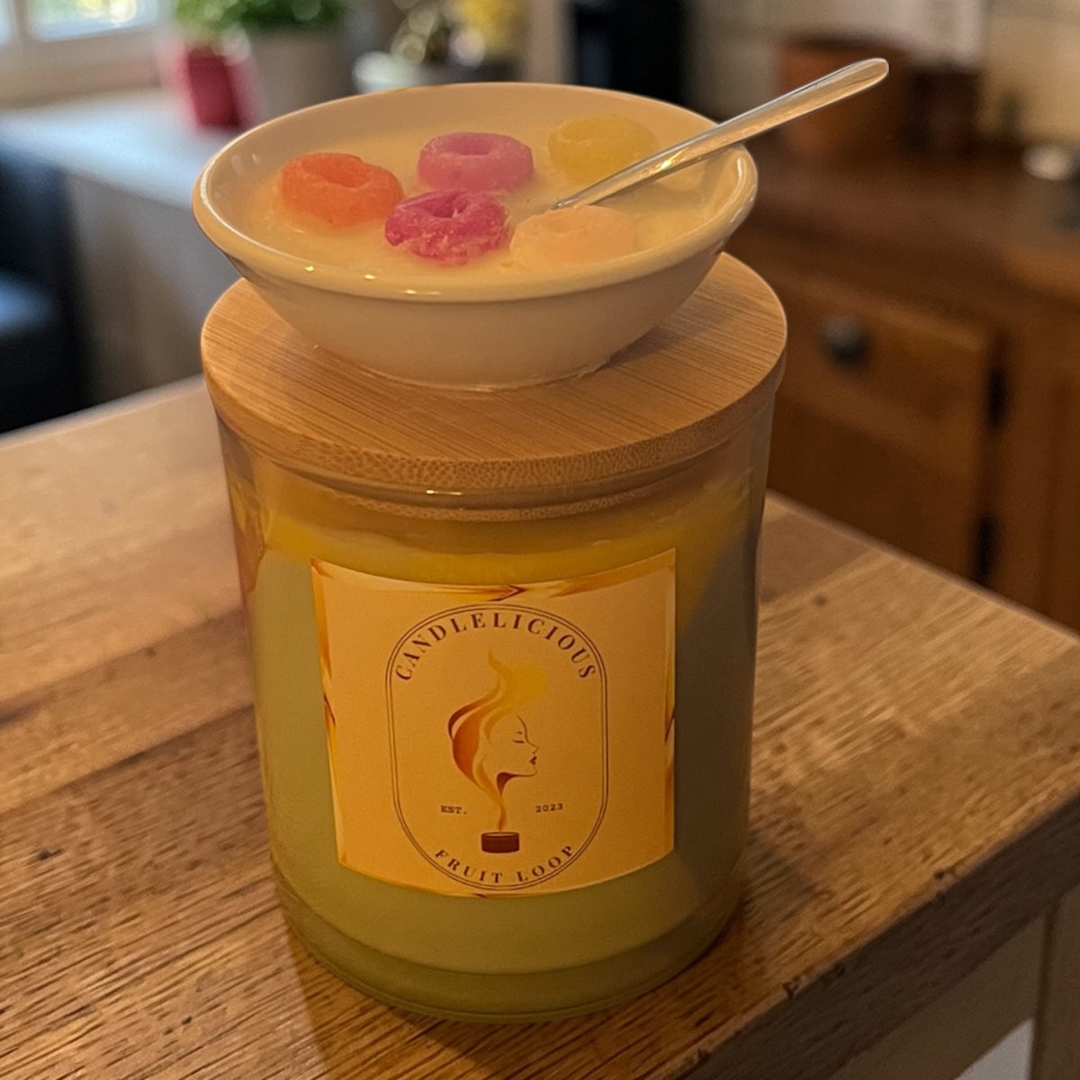 Fruit Loop candle with a bowl of cereal on the lid, photographed at home