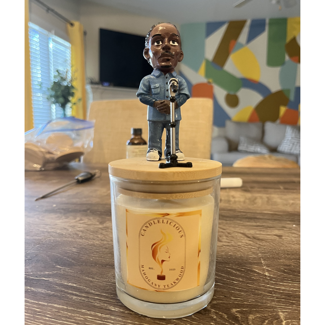 Mahogany Teakwood candle with a figurine in denim at a microphone on the lid