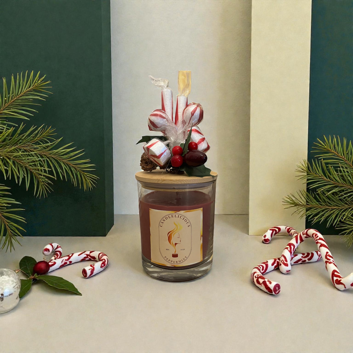 Peppermint candle with candy canes, peppermint candies and holly berries on the lid