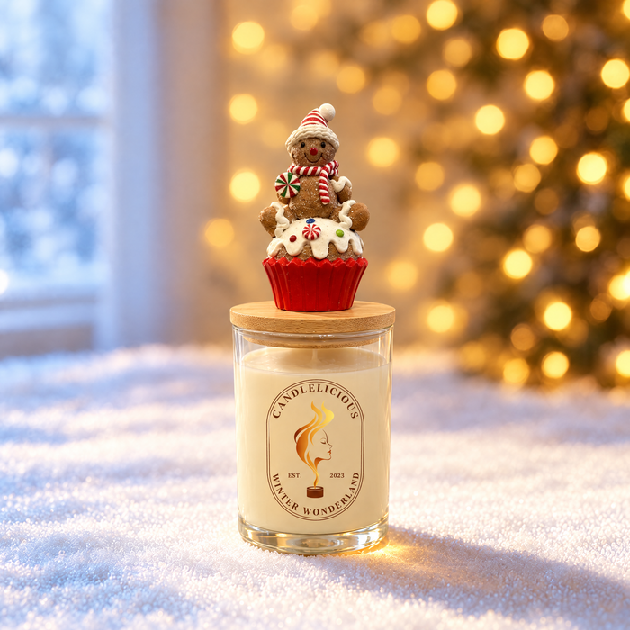 Winter Wonderland candle with a gingerbread cupcake on the lid, standing in snow