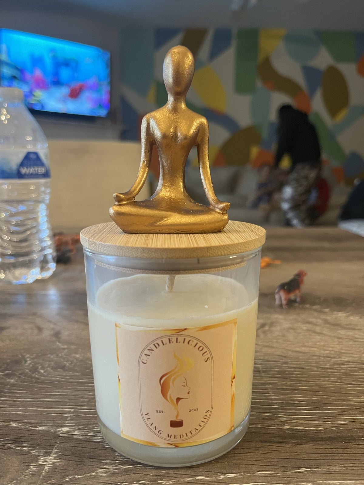 Ylang Meditation candle with a gold seated figure on the lid