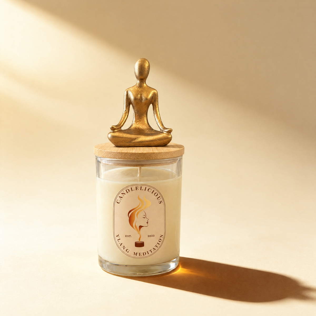 Ylang Meditation candle with a gold meditating figure on the lid