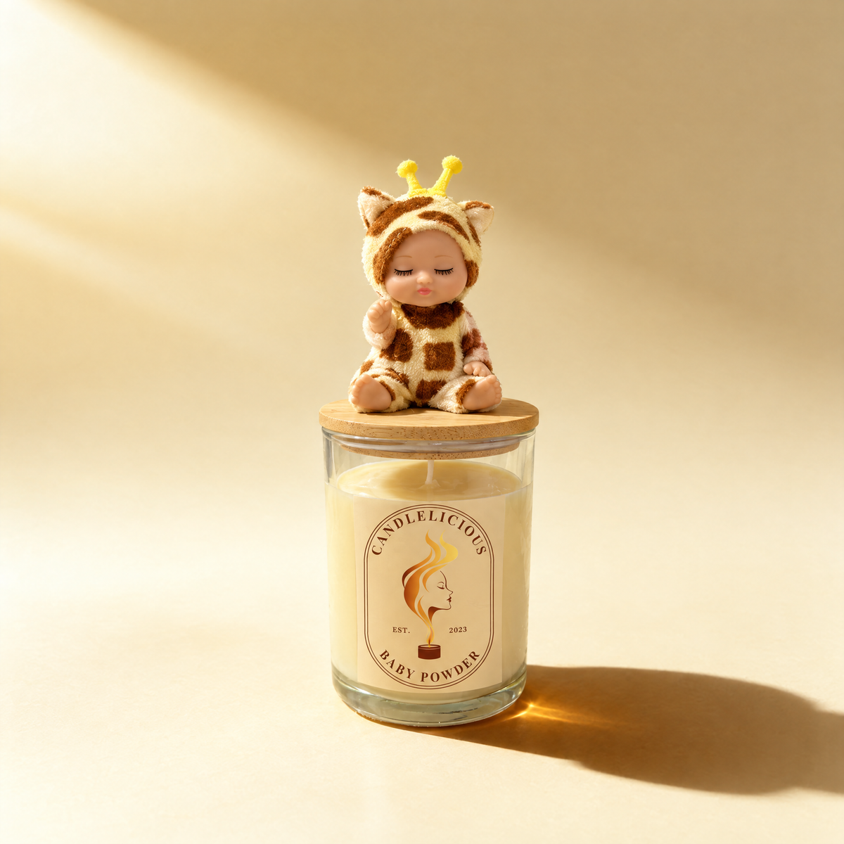 Baby Powder candle with a sleeping baby in a giraffe suit on the lid