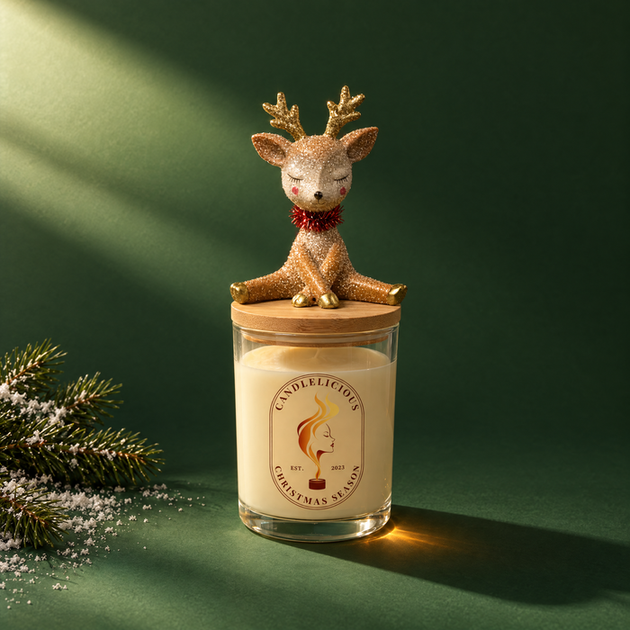 Christmas Season candle with a glitter reindeer on the lid, on an evergreen backdrop