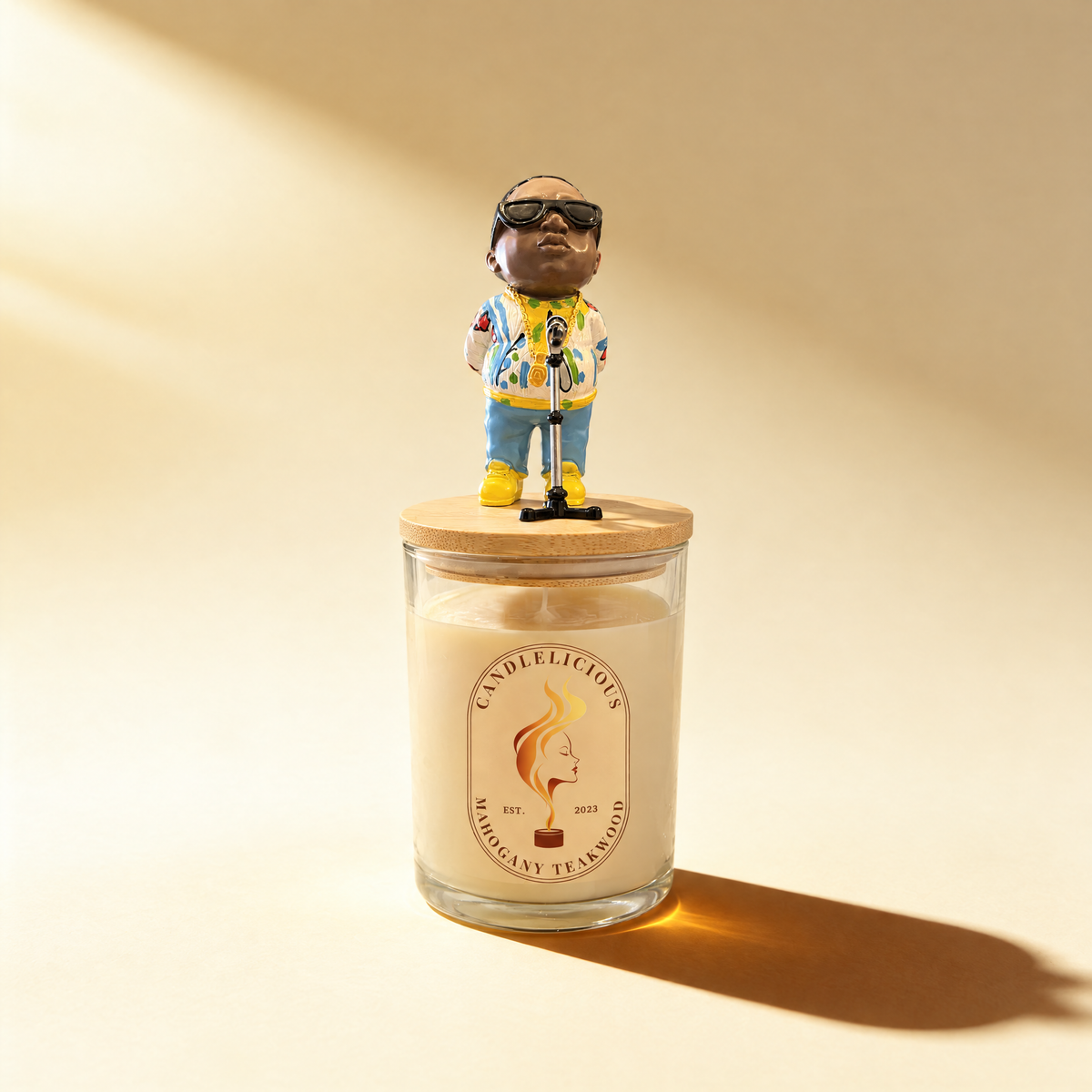 Mahogany Teakwood candle with a Biggie figurine at a microphone on the lid