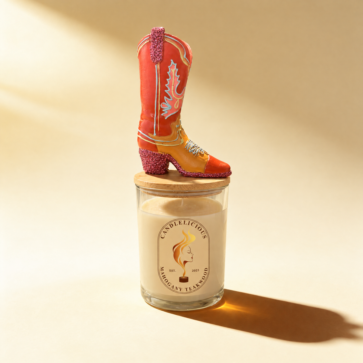 Mahogany Teakwood candle with a red cowgirl boot on the lid