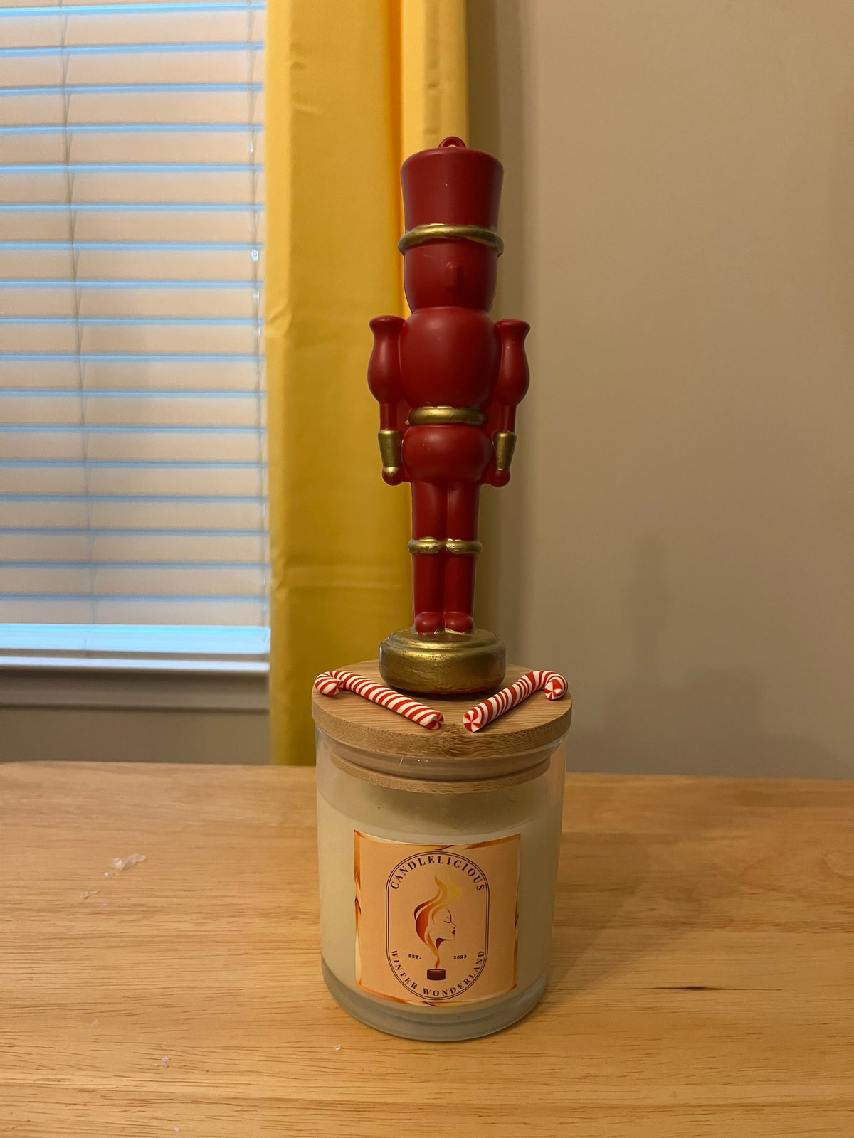 Winter Wonderland candle with a red and gold nutcracker on the lid