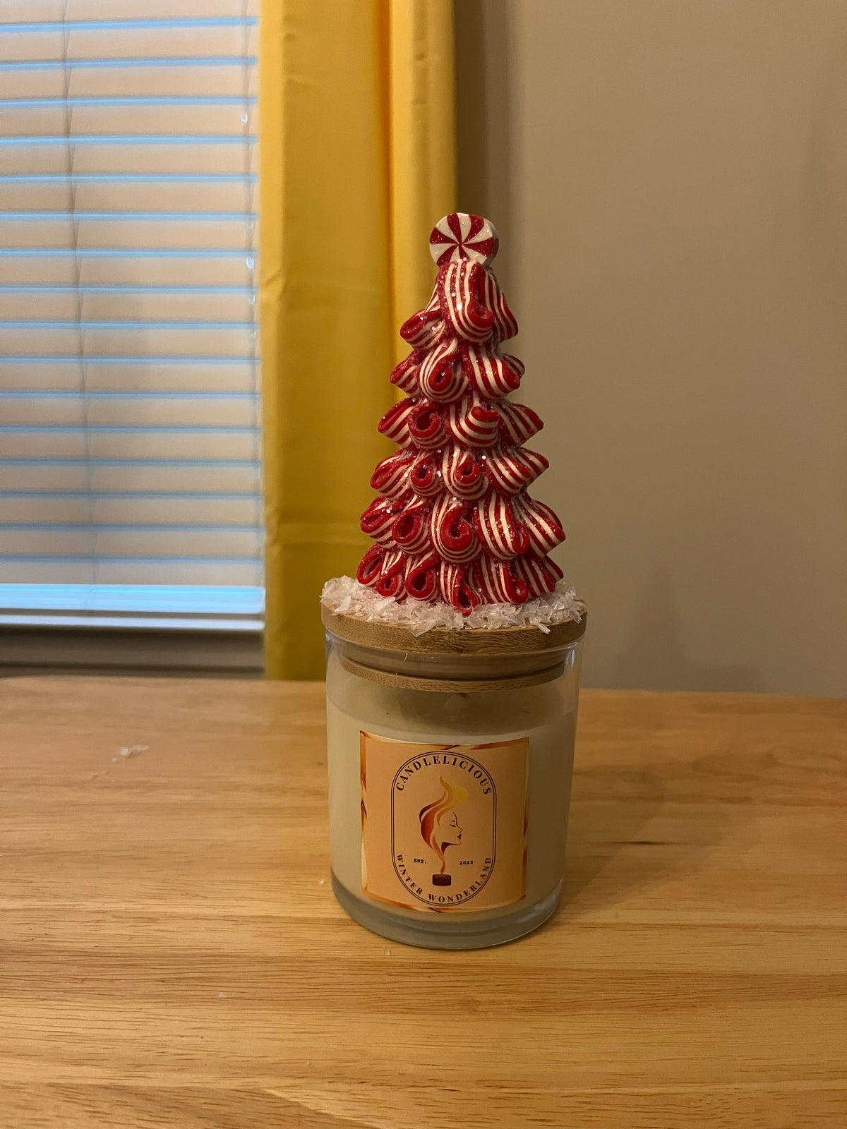 Winter Wonderland candle with a candy-stripe tree topped with a peppermint on the lid