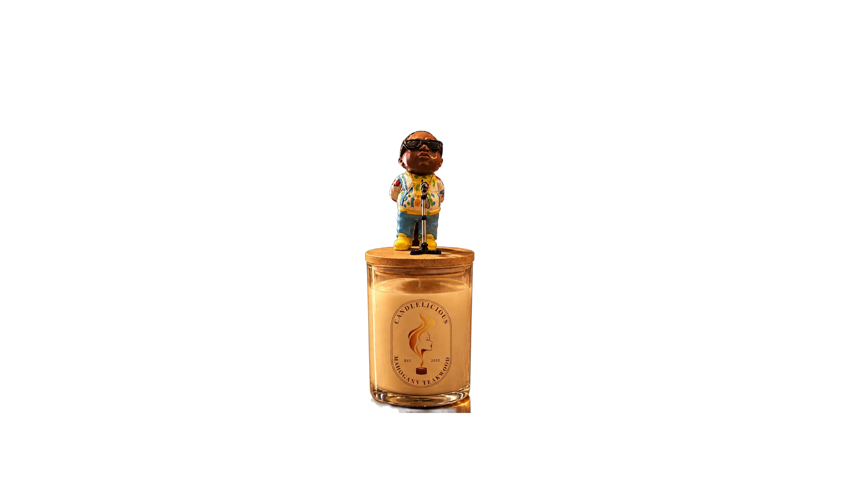 Mahogany Teakwood candle with a Biggie figurine at a microphone on the lid, on a bedroom dresser at night
